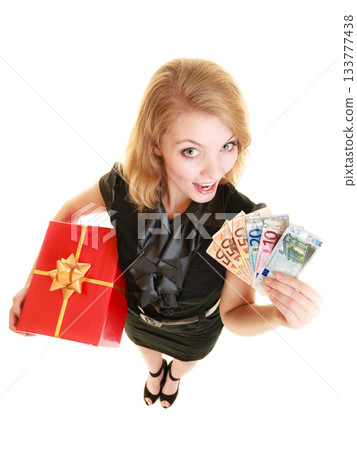 Woman with gift box and euro currency money banknotes. 133777438