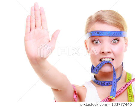 Obsessed fitness woman with a lot of colorful measure tapes Obsessed fitness woman with a lot of colorful measure tapes 133777440