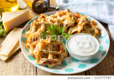Crispy cheese waffles on a rustic background. Crispy cheese waffles on a rustic background. 133777797