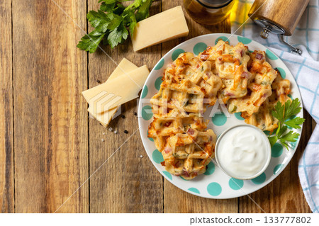 Crispy cheese waffles on a rustic background. Top view. 133777802