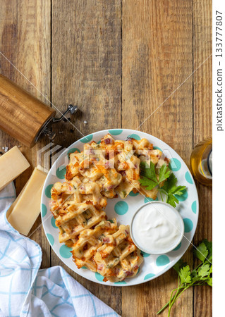 Crispy cheese waffles on a rustic background. Top view flat lay. Crispy cheese waffles on a rustic background. Top view flat lay. 133777807