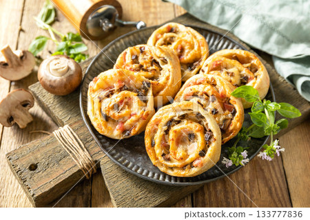 Puff pastry rolls with mushroom and cheese filling on rustic background. 133777836