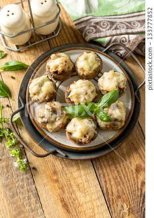 Stuffed mushrooms baked with cheese on rustic background. Copy space. 133777852