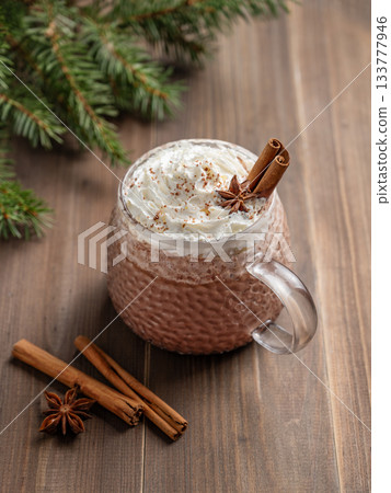 Hot chocolate with whipped cream in a cup on a dark wooden background Hot chocolate with whipped cream in a cup on a dark wooden background 133777946
