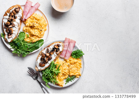 Healthy balanced breakfast with scrambled eggs, sandwich, ham 133778499