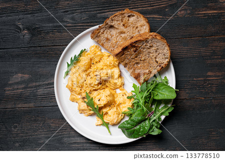 Scrambled eggs with greens for breakfast 133778510