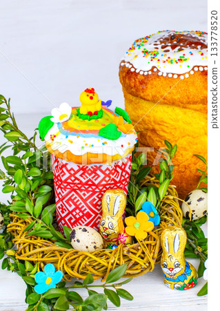 Easter cake and painted eggs, white flowers, festive composition in rustic style,ukrainian orthodox tradition, vintage wooden background, selective focus 133778520