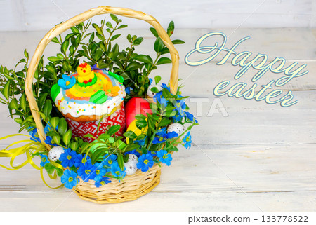 Easter composition. Easter cake and painted eggs, white flowers, festive composition in rustic style,ukrainian orthodox tradition, vintage wooden background, selective focus 133778522