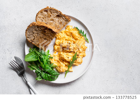 Scrambled eggs with greens for breakfast 133778525
