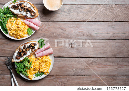 Healthy balanced breakfast with scrambled eggs, sandwich, ham 133778527