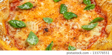 Freshly baked Margherita pizza with golden melted cheese, tomato sauce, and vibrant basil leaves, captured in a delicious close-up ideal for food menus, restaurant promotions, and culinary advertising Freshly baked Margherita pizza with golden melted cheese, tomato sauce, and vibrant basil leaves, captured in a delicious close-up ideal for food menus, restaurant promotions, and culinary advertising 133778551