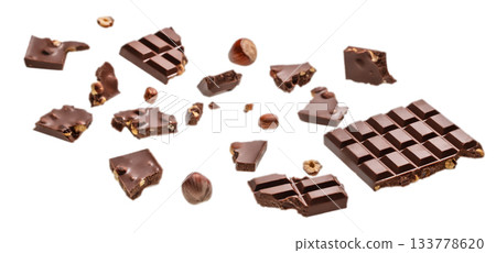 Assorted broken milk chocolate pieces with hazelnuts isolated on white background 133778620