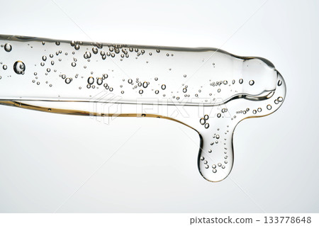 Cosmetic pipette dispensing serum with bubbles macro Cosmetic pipette dispensing serum with bubbles macro 133778648