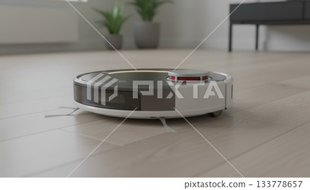 Robot vacuum moving across a light wooden floor, representing smart home automation and efficient household technology for modern living and domestic cleaning convenience 133778657