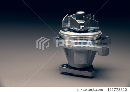 Engine cooling pump, engine coolant pump for a passenger car on a black gradient background. Selective focus Engine cooling pump, engine coolant pump for a passenger car on a black gradient background. Selective focus 133778820