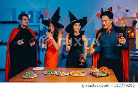 Joyful office Halloween party with coworkers in costumes, celebrating with drinks and laughter, fostering teamwork and festive spirit 133779296