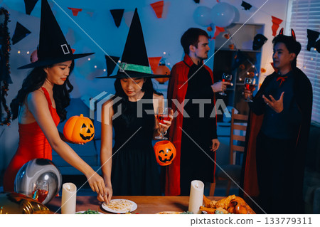 Joyful office Halloween party with coworkers in costumes, celebrating with drinks and laughter, fostering teamwork and festive spirit 133779311
