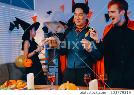 Joyful office Halloween party with coworkers in costumes, celebrating with drinks and laughter, fostering teamwork and festive spirit 133779319