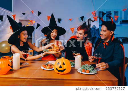 Joyful office Halloween party with coworkers in costumes, celebrating with drinks and laughter, fostering teamwork and festive spirit 133779327