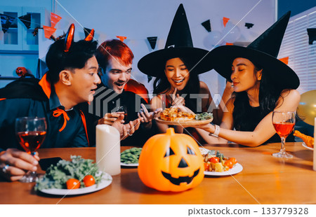 Joyful office Halloween party with coworkers in costumes, celebrating with drinks and laughter, fostering teamwork and festive spirit 133779328