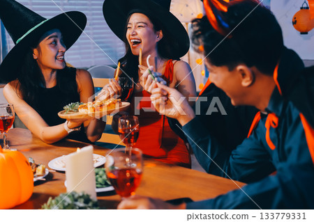 Joyful office Halloween party with coworkers in costumes, celebrating with drinks and laughter, fostering teamwork and festive spirit 133779331