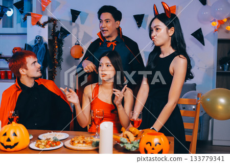 Joyful office Halloween party with coworkers in costumes, celebrating with drinks and laughter, fostering teamwork and festive spirit 133779341