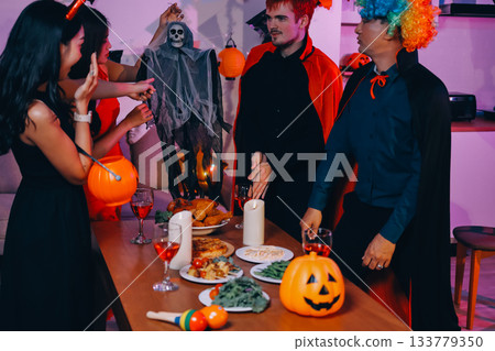 Joyful office Halloween party with coworkers in costumes, celebrating with drinks and laughter, fostering teamwork and festive spirit 133779350