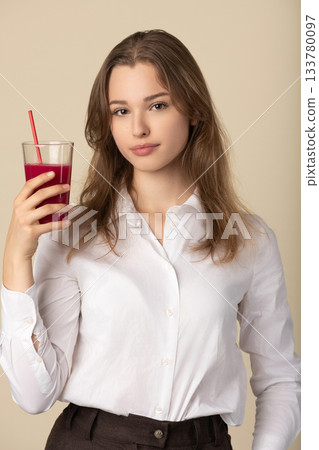 Beautiful woman drinking red juice with straw Beautiful woman drinking red juice with straw 133780097