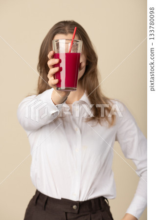 Beautiful woman drinking red juice with straw Beautiful woman drinking red juice with straw 133780098