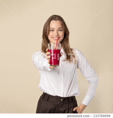 Beautiful woman drinking red juice with straw 133780099