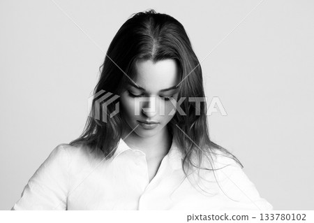 Beautiful woman studio black and white portrait against bright background 133780102