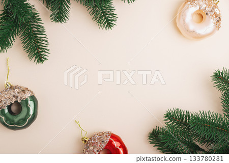 Christmas Donuts Ornaments and Pine Branches on Light Beige Background 133780281
