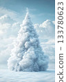 Majestic snow-covered Christmas tree under a bright winter sky at a peaceful location 133780623