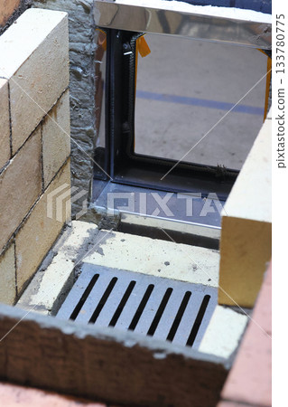 Fireclay masonry of the firebox. Grate and firebox door. Construction of a heating stove. Close-up. 133780775