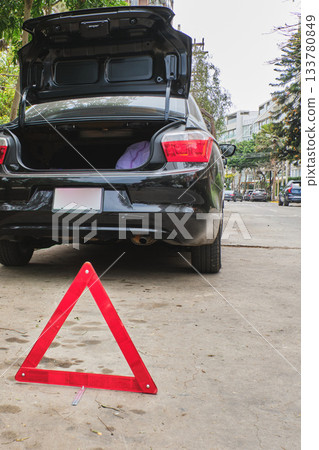 Car breakdown with warning triangle on road 133780849