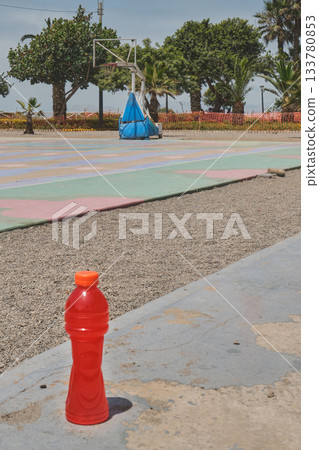 Sports drink hydrating on outdoor basketball court Sports drink hydrating on outdoor basketball court 133780853