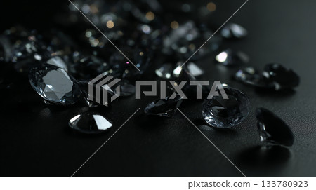 photo black crystals scattered on the  black plane, can be used as poster or banner 133780923