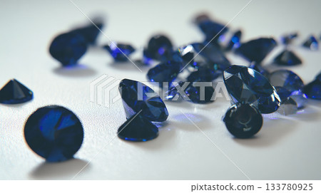 photo of dark blue crystals scattered on matte white surface, can be used as poster or banner 133780925