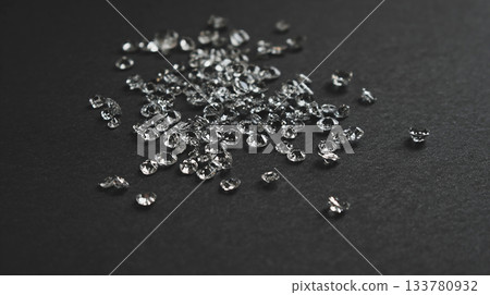 photo of white crystals scattered on black matte plane, can be used as poster or banner photo of white crystals scattered on black matte plane, can be used as poster or banner 133780932