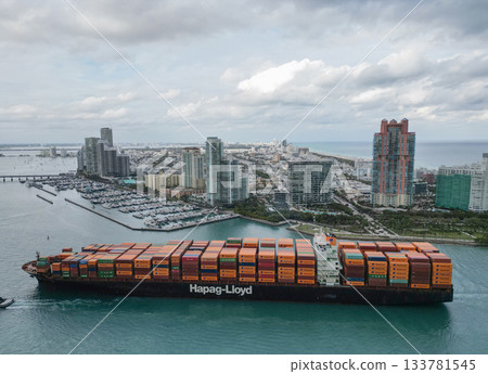 Miami, Florida, USA - January 16, 2025: Container ship. Cargo ship with container in Miami, Hapag Lloyd. Freight container loaded on cargo vessel in Miami. Aerial view cargo ship entering harbor Miami, Florida, USA - January 16, 2025: Container ship. Cargo ship with container in Miami, Hapag Lloyd. Freight container loaded on cargo vessel in Miami. Aerial view cargo ship entering harbor 133781545