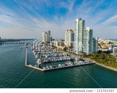 Port with yacht. Yachting marina. Luxury yacht charter. Miami port marina. Luxury yachting in summer. Docked yacht in port of Miami. Marina luxury cityscape. Docked boats at marina Port with yacht. Yachting marina. Luxury yacht charter. Miami port marina. Luxury yachting in summer. Docked yacht in port of Miami. Marina luxury cityscape. Docked boats at marina 133781587