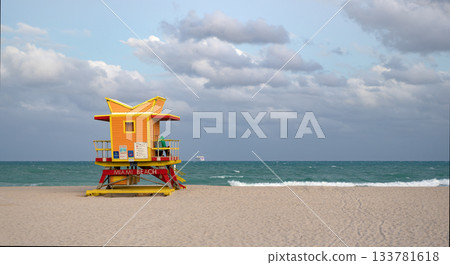 Lifeguard on beach in Miami. Travel and sea resort. Lifeguard station at beach. Lifeguard tower at the sea beach. Summer vacation. Vacation on summer seaside. Relax at the sea. Banner advertisement 133781618
