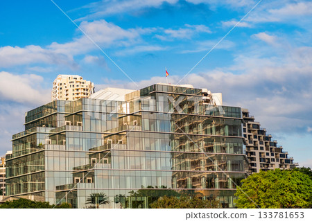 Modern glass building. Building in business city. City downtown architecture. Office building in city district. Brickell Key. Glass building architecture. Architectural glassy exterior 133781653