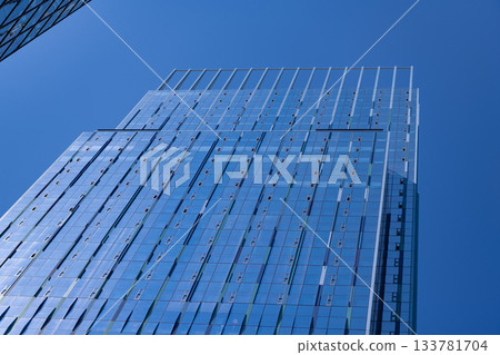 Glass skyscraper. City architecture. Architecture of office building. Skyscraper architecture. Business skyscraper building. Architectural building business area. Elegant glass office Glass skyscraper. City architecture. Architecture of office building. Skyscraper architecture. Business skyscraper building. Architectural building business area. Elegant glass office 133781704