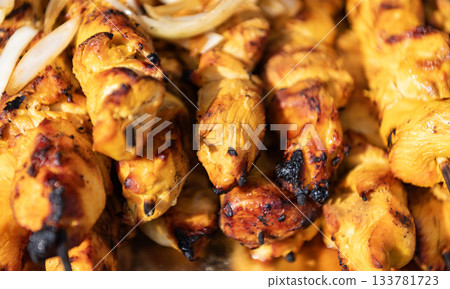 Chicken meat on skewer. Chicken on BBQ grill. Barbecue grill. Grilled poultry kebab. Delicious shish kebab. Grilled BBQ. Skewer meat cooking on barbecue, rotisserie shashlik Chicken meat on skewer. Chicken on BBQ grill. Barbecue grill. Grilled poultry kebab. Delicious shish kebab. Grilled BBQ. Skewer meat cooking on barbecue, rotisserie shashlik 133781723