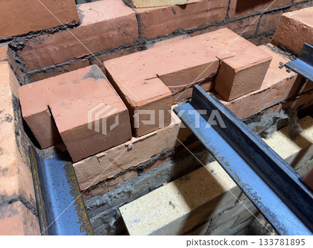 Installation of the heating stove ceiling with bricks on metal angles. Construction of a heating stove. Installation of the heating stove ceiling with bricks on metal angles. Construction of a heating stove. 133781895