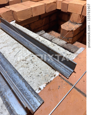 Installation of the heating stove ceiling. With concrete slabs and bricks on metal angles. Construction of a heating stove. 133781907