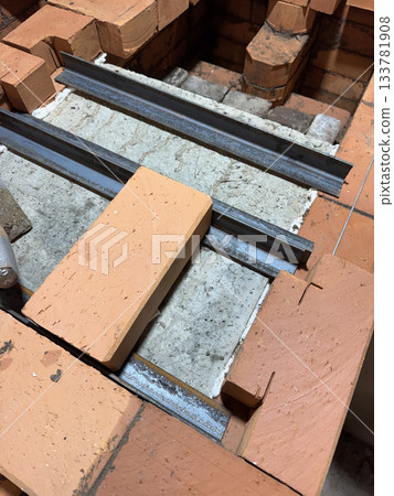 Installation of the heating stove ceiling. With concrete slabs and bricks on metal angles. Construction of a heating stove. Installation of the heating stove ceiling. With concrete slabs and bricks on metal angles. Construction of a heating stove. 133781908