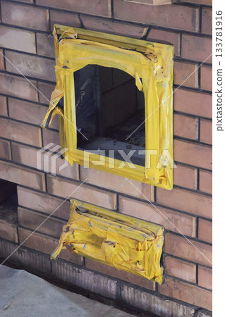 Visible through the firebox and ash pan doors, wrapped with insulation tape to prevent moisture ingress. Construction of a heating stove. Visible through the firebox and ash pan doors, wrapped with insulation tape to prevent moisture ingress. Construction of a heating stove. 133781916