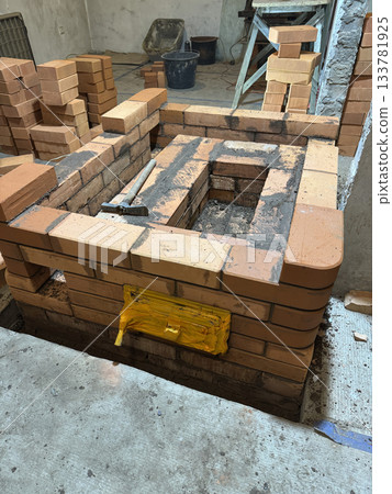 Construction of a heating stove. Brickwork of the stove core with its caps. 133781925